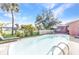 Inviting backyard pool, perfect for relaxation with lounge chairs and palm trees surrounding at 2031 Backton St, Port Charlotte, FL 33948