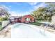 The backyard pool is surrounded by lounge chairs and a privacy fence at 2031 Backton St, Port Charlotte, FL 33948