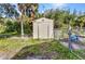 Storage shed with fence and landscaping at 2031 Backton St, Port Charlotte, FL 33948