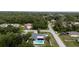 A serene home featuring solar panels and a backyard pool surrounded by lush trees at 21220 Pemberton Ave, Port Charlotte, FL 33952