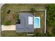 An overhead view of home with pool, lush landscaping, driveway, and fenced-in yard at 21220 Pemberton Ave, Port Charlotte, FL 33952