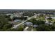 Residential aerial showcases homes, and foliage of a lush neighborhood, with water feature at 21220 Pemberton Ave, Port Charlotte, FL 33952