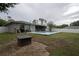 Spacious backyard with a pool, outdoor seating, and lush greenery for relaxed outdoor enjoyment at 21220 Pemberton Ave, Port Charlotte, FL 33952