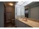 Bright bathroom with vanity, mirror, and shower with decorative curtain at 21220 Pemberton Ave, Port Charlotte, FL 33952