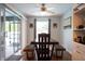 Open dining room with a view of the patio, featuring a large window and stylish wood furniture at 21220 Pemberton Ave, Port Charlotte, FL 33952