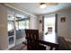 Bright dining room with a view of the patio, featuring a large window and stylish wood furniture at 21220 Pemberton Ave, Port Charlotte, FL 33952