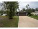 Inviting one-story home with a manicured lawn and a spacious concrete driveway at 21220 Pemberton Ave, Port Charlotte, FL 33952