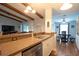 Bright kitchen with stainless appliances, breakfast bar, and open to the living space at 21220 Pemberton Ave, Port Charlotte, FL 33952