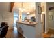 Open kitchen and breakfast bar area with beams, white cabinets and stainless appliances at 21220 Pemberton Ave, Port Charlotte, FL 33952