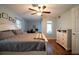 Comfortable main bedroom with hardwood floors, a ceiling fan, and a large window for natural light at 21220 Pemberton Ave, Port Charlotte, FL 33952