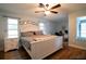 Spacious main bedroom featuring wood floors, lots of natural light and ceiling fan at 21220 Pemberton Ave, Port Charlotte, FL 33952