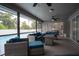 Relaxing screened-in patio with comfortable seating and ceiling fans, overlooking a sparkling pool at 21220 Pemberton Ave, Port Charlotte, FL 33952
