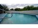 Inviting pool with a cool blue hue, a tranquil escape within a fenced yard at 21220 Pemberton Ave, Port Charlotte, FL 33952