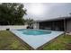 Backyard featuring a pristine pool, covered patio, and well-maintained lawn, creating a private oasis at 21220 Pemberton Ave, Port Charlotte, FL 33952