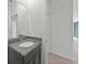 Modern bathroom showcasing a granite vanity with chrome fixtures, white walls and view to hall at 2138 Blaser St, Punta Gorda, FL 33980