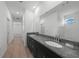 Bathroom with dual sinks, granite countertop, and large mirror at 2138 Blaser St, Punta Gorda, FL 33980