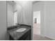 Modern bathroom showcasing a granite vanity with chrome fixtures, white walls and view to hall at 2138 Blaser St, Punta Gorda, FL 33980