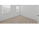 Well-lit bedroom with two windows, neutral carpet, and fresh white walls at 2138 Blaser St, Punta Gorda, FL 33980