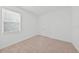 Carpeted bedroom with a window and double door closet at 2138 Blaser St, Punta Gorda, FL 33980