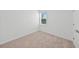 Well-lit bedroom with a window, neutral carpet, and fresh white walls at 2138 Blaser St, Punta Gorda, FL 33980