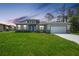 Charming exterior showcasing a well-maintained lawn and attached two car garage at 2138 Blaser St, Punta Gorda, FL 33980