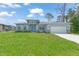 Beautiful single-Gathering home with a well-manicured lawn, blue door and a two-car garage at 2138 Blaser St, Punta Gorda, FL 33980