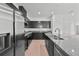 Modern kitchen with granite countertops, dark cabinets, and stainless steel appliances at 2138 Blaser St, Punta Gorda, FL 33980