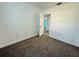 Bedroom with neutral carpet, and a door to the bathroom at 21899 Cellini Ave, Port Charlotte, FL 33952