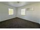 Bedroom featuring two windows providing natural light and neutral carpeting at 21899 Cellini Ave, Port Charlotte, FL 33952