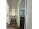Hallway with wood flooring and white walls leading to bedroom and living areas at 21899 Cellini Ave, Port Charlotte, FL 33952
