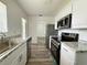 Modern kitchen with granite countertops, stainless steel appliances, and ample cabinet space at 21899 Cellini Ave, Port Charlotte, FL 33952