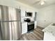 Bright kitchen featuring stainless steel appliances and white cabinetry with gray and white countertop at 21899 Cellini Ave, Port Charlotte, FL 33952