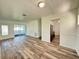 Open-concept living space with wood-look floors seamlessly connecting the living area with the rest of the home at 21899 Cellini Ave, Port Charlotte, FL 33952