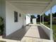 A covered patio area provides outdoor space next to the home at 21899 Cellini Ave, Port Charlotte, FL 33952