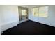 Sunroom with carpeting, many windows, and a sliding glass door at 21899 Cellini Ave, Port Charlotte, FL 33952