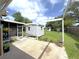 Outdoor space with a covered patio, shed, and well-maintained lawn with mature trees and landscaping at 22334 Augusta Ave, Port Charlotte, FL 33952
