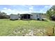 Large backyard featuring a shed, screened-in porch, and well-maintained lawn, offering privacy and space at 22334 Augusta Ave, Port Charlotte, FL 33952