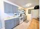 Updated kitchen featuring modern appliances, white subway tile backsplash, and gray shaker style cabinetry at 22334 Augusta Ave, Port Charlotte, FL 33952