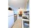 Open-concept kitchen featuring updated appliances, white backsplash, wood countertops, and seamless flow into dining/living areas at 22334 Augusta Ave, Port Charlotte, FL 33952