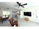 Bright living room featuring a ceiling fan, an open-concept design, and a view of the kitchen at 22334 Augusta Ave, Port Charlotte, FL 33952
