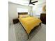 Bright bedroom featuring a large bed with an eye-catching yellow comforter and plush pillows at 22334 Augusta Ave, Port Charlotte, FL 33952