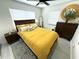 Sunlit bedroom featuring a ceiling fan, ample closet space, and stylish decor at 22334 Augusta Ave, Port Charlotte, FL 33952