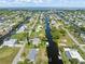 An aerial view featuring a waterfront community, homes and canals surrounded by lush scenery and landscaping at 24398 Treasure Island Blvd, Punta Gorda, FL 33955