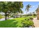 Backyard featuring a waterfront view, dock, lush lawn and mature landscaping at 24398 Treasure Island Blvd, Punta Gorda, FL 33955