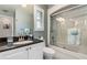 Bathroom with granite counters, updated fixtures, and glass enclosed shower at 24398 Treasure Island Blvd, Punta Gorda, FL 33955