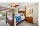 Bedroom features a decorative ceiling fan, natural lighting, and neutral paint at 24398 Treasure Island Blvd, Punta Gorda, FL 33955