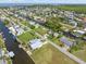 Aerial view of a waterfront community featuring private canals and docks surrounded by lush tropical landscaping at 24398 Treasure Island Blvd, Punta Gorda, FL 33955