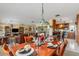 Bright dining room adjacent to living room and kitchen, with table set for service at 24398 Treasure Island Blvd, Punta Gorda, FL 33955