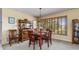 Traditional dining room featuring a wood table set for four, complemented by classic furnishings and natural light at 24398 Treasure Island Blvd, Punta Gorda, FL 33955