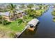 Waterfront home featuring a boat dock, lush tropical landscaping, and a tranquil canal view for serene living at 24398 Treasure Island Blvd, Punta Gorda, FL 33955